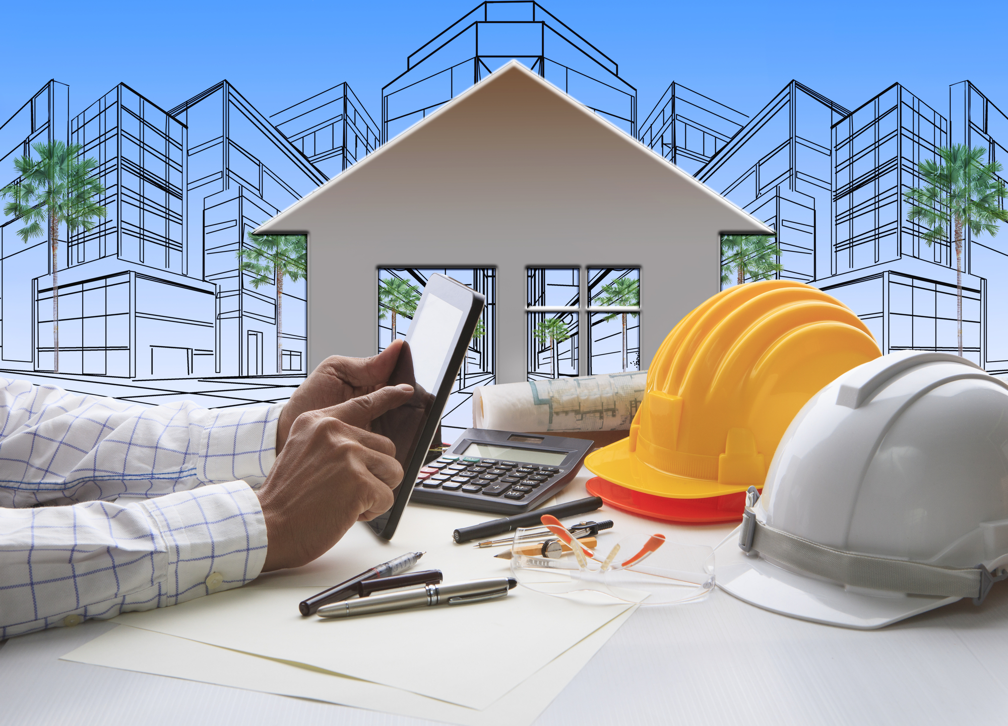 hand of architect working on computer tablet  with construction industry and engineer working tool on top of table against home out line and sketching of modern building perspective